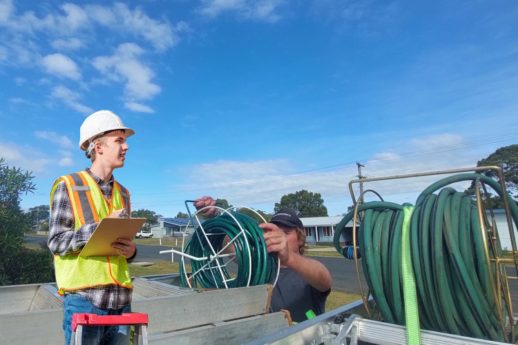 
Gutter cleaner in wollongong loads hoses following thorough gutter rinsing.