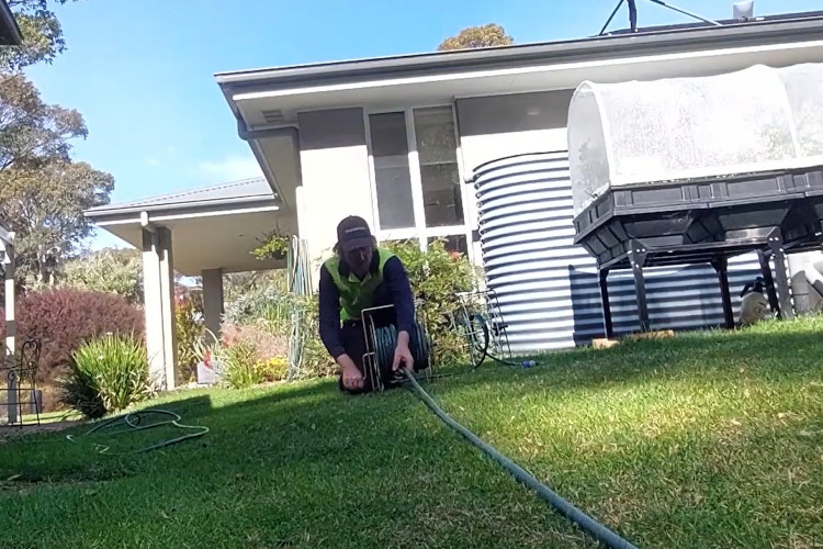 
Closing out the day, the wollongong downpipe cleaner is wrapping up his hose.